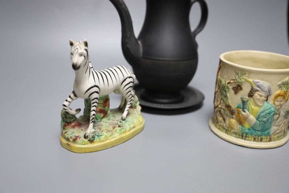 A 19th century Staffordshire pottery model of a zebra, a Victorian relief-moulded frog mug, a black basalt coffee pot with cover on sta